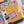 Jigsaw puzzle with a completed section showing a pillow on a chair with books and a cup.