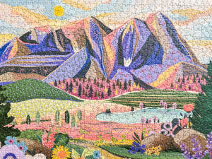 Completed jigsaw puzzle of an illustration of beautiful mountain and valley scene. 