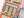 Partial view of a jigsaw puzzle showing an illustration of a bookshop with colorful design.