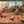 Classical painting of a garden scene with people and flowers