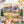Hand holding a poster of Mountains & Valley puzzle artwork showing illustrated mountain and valley scene. 