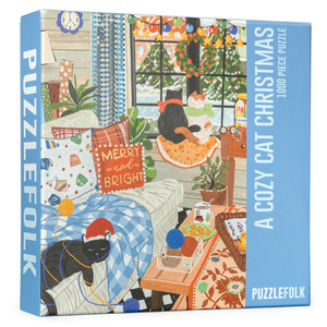 Blue puzzle box with an image of several cats in a room decorated for the holidays. 