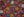 Colorful puzzle art showing a top view of a flower market including bunches of flowers and figures.