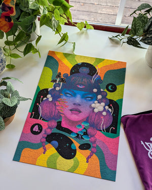 Colorful puzzle illustration of a woman's face with psychedelic mushrooms and colorful stripes on a white surface with plants in the background