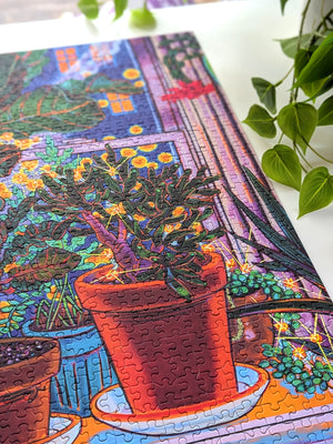 Colorful puzzle with a completed section featuring potted plants on a white surface.