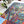Colorful puzzle with a nature-themed design on a white surface, next to a potted plant.