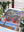 Colorful puzzle with a floral design on a table surrounded by plants