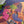 Close up of completed puzzle showing two women chatting with each other with drinks and snacks on a tray nearby. 