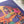 Close up detail of Girls Night puzzle shown on white table top with plants nearby. Illustration on puzzle shows women chatting with each other. 