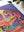 Close up detail of Girls Night puzzle shown on white table top with plants nearby. Illustration on puzzle shows women chatting with each other. 