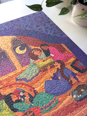 Close up detail of Girls Night puzzle shown on white table top with plants nearby. Illustration on puzzle shows women chatting with each other. 