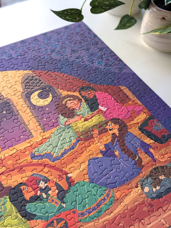 Close up detail of Girls Night puzzle shown on white table top with plants nearby. Illustration on puzzle shows women chatting with each other. 