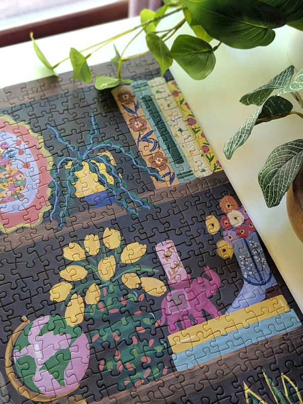 Jigsaw puzzle with floral design on a table with plants in the background