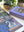 Jigsaw puzzle with close up of corner showing a swan planter illustration on a table next to the packaging titled 'Shelf of Whimsy'.