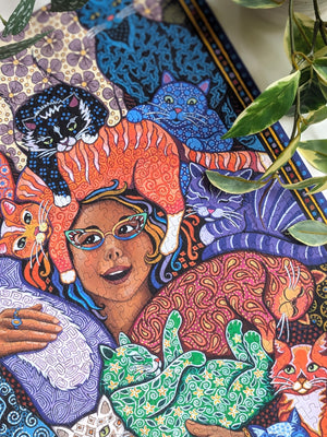 Colorful puzzle illustration of a woman with cats on her head and around her. 