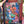 Woman's hand holding Art & Fable puzzle box showing an illustration woman holding many different patterned cats. 