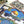 Partially completed puzzle showing an illustration of a domed building with a pool and pigeons, framed by an archway.