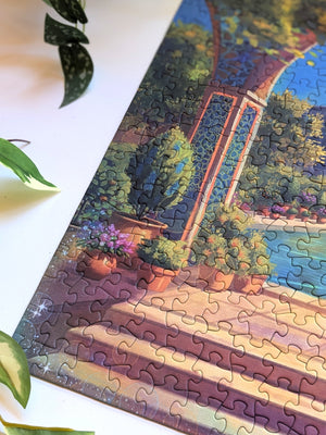 Close up of completed puzzle showing corner of illustration featuring steps, an arched doorway and potted plants.