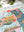 A close-up of a completed jigsaw puzzle featuring colorful text and botanical illustrations.