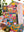 A hand holds a colorful patchwork jigsaw puzzle box labeled 'CHOOSE HAPPY! 1000 PIECE PUZZLE' by PuzzleFolk, with a matching completed jigsaw puzzle visible in the background.