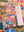 Puzzle box with colorful patchwork art collage atop a completed version of the puzzle. 