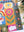 Partial view of a complete jigsaw puzzle featuring colorful floral motifs on a white surface near a potted plant. 