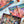Open jigsaw puzzle box with pieces on top of a poster of the puzzle showing nighttime desert scenery. Box and poster are on white surface surrounded by box lid and stones. 