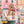 Hand holding colorful puzzle pieces with a blurred multicolored background of the completed puzzle.