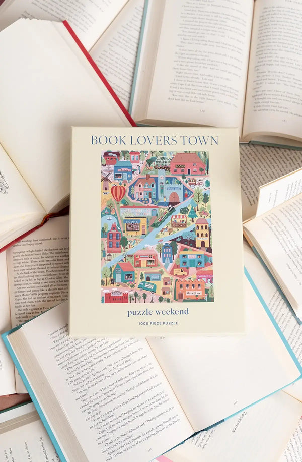 Puzzle box with a colorful illustration of a town on a background of open books