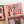 A close-up of a completed jigsaw puzzle featuring a pink and orange Halloween design with the words 'Trick or Treat' in decorative lettering, along with pumpkins, ghosts, and a witch illustration, photographed on a white background.
