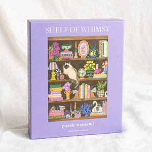 Puzzle box titled 'Shelf of Whimsy' with an illustration of a cat on a bookshelf.