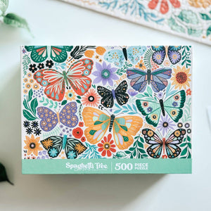 Puzzle box with colorful butterfly and floral design on a white surface