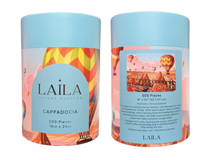 Two cylindrical puzzle boxes with 'Laila' branding and scenic illustrations on a white background.