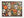 A completed jigsaw puzzle featuring a colorful Halloween collage with sugar skulls, jack-o'-lanterns, butterflies, leaves, candles, and spiders on a dark background, photographed against a plain white backdrop.