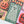 Partial view of a completed Halloween-themed jigsaw puzzle centered on the artwork of a floral designed ghost on muted green background with stars, also visible are a pumpkin, candy corn, eyeball and living flowers with sharp teeth. 
