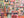 A 1000-piece jigsaw puzzle box titled by Spaghetti Tree puzzles featuring a colorful collage of Halloween-themed illustrations like pumpkins, ghosts, houses, and 'Happy Halloween' signs, set atop an out of focus shot of the completed puzzle.