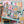 Puzzle box with colorful design featuring books and a cat, set against a a out of focus version of the completed puzzle in the background.
