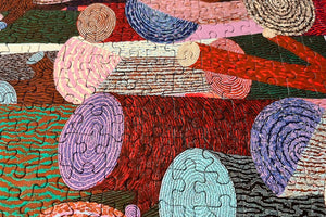 Close up of puzzle details showing colorful abstract artwork of logs created with circular patterns and vibrant colors