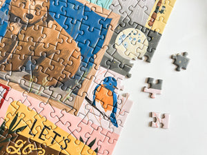 Jigsaw puzzle with a partially completed design of a bear and bird on a white background