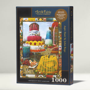 Jigsaw puzzle box with colorful surreal artwork showing tiny people among large jello-like foods. Art & Fable Puzzle Company branding.