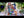 YouTube video of a top down view time lapse of the Cat Lady jigsaw puzzle being put together on a white desk surrounded by plants.
